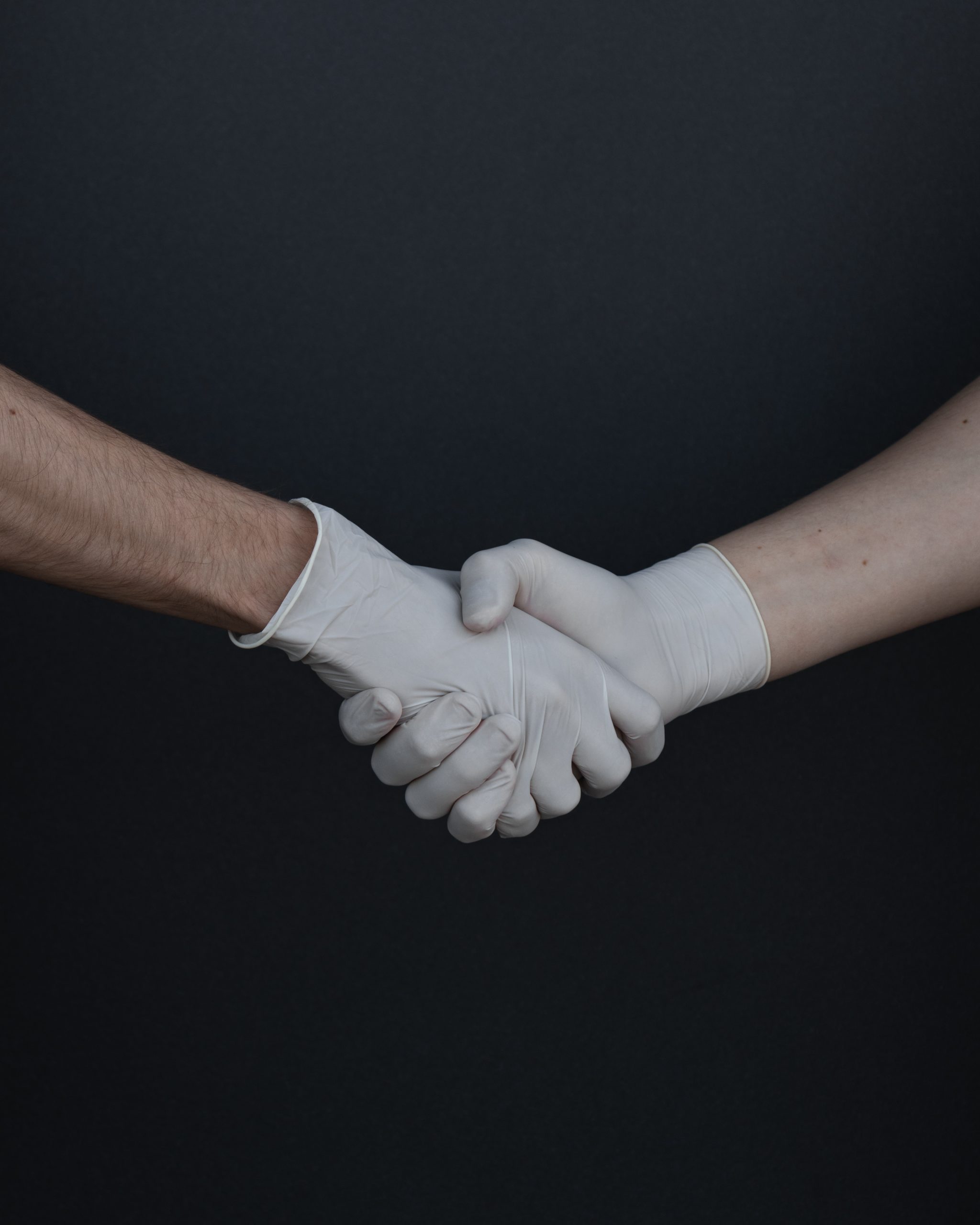 shaking hands with gloves