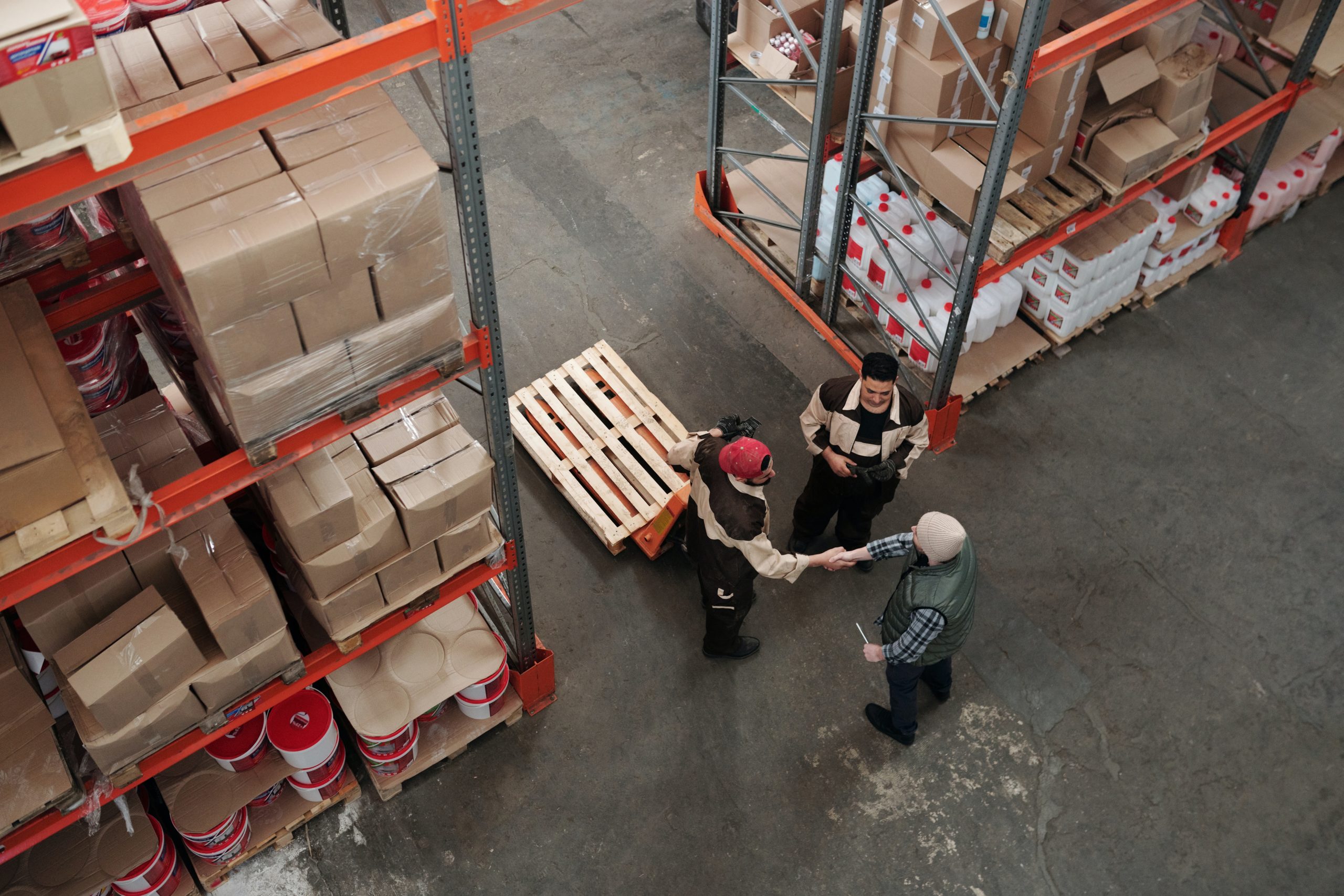 Two men in a warehouse shaking hands