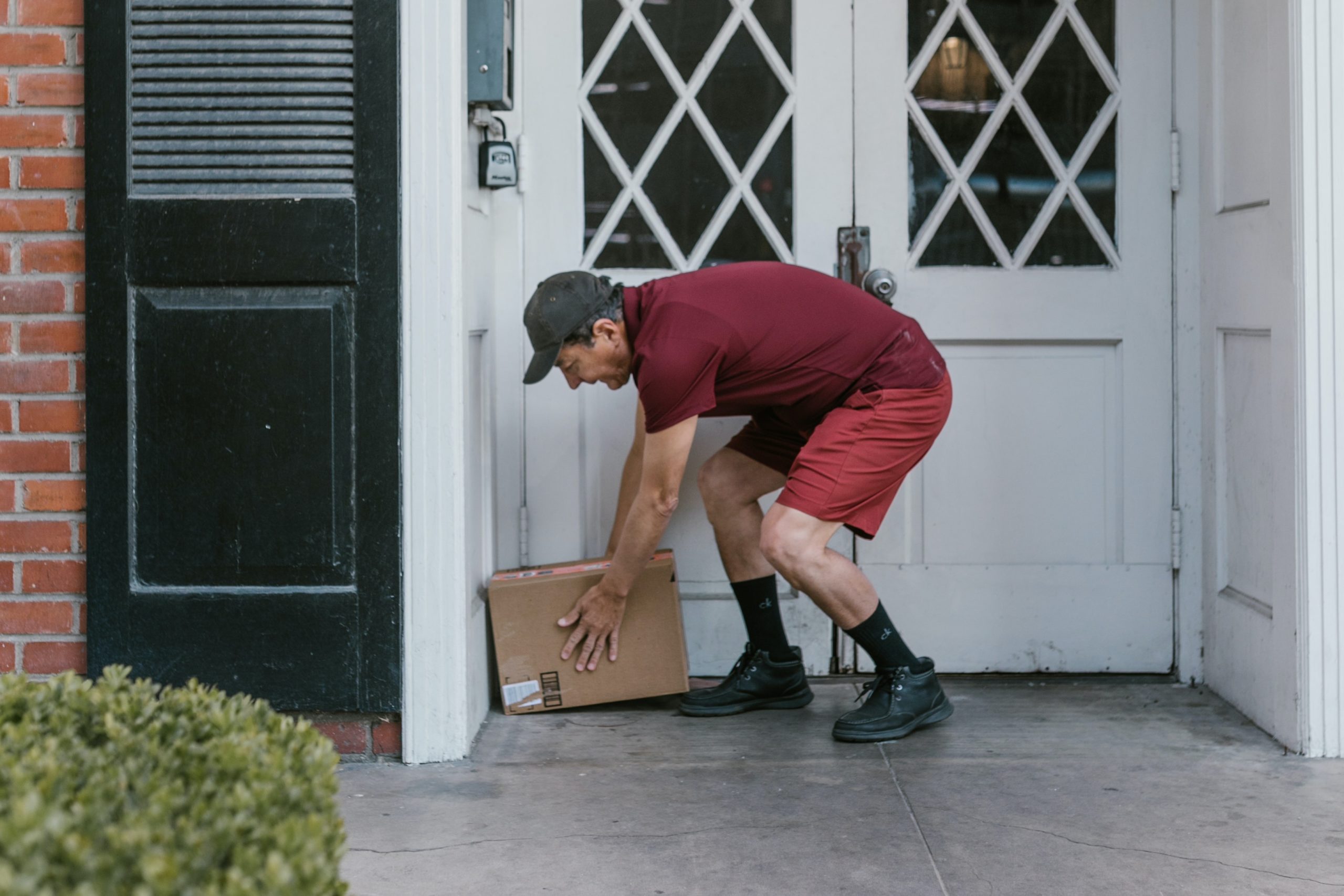Man Dropping off a Package On A Doorstep