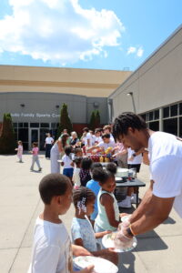 Axle Logistics volunteers serving lunch at the Boys & Girls Clubs of the Tennessee Valley Summer Kickoff Party through Axle Impact